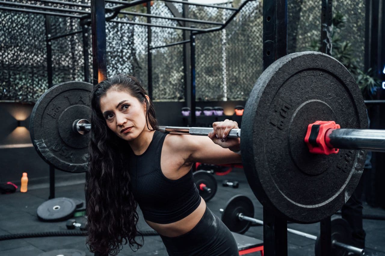 Woman lifting weights in a modern gym