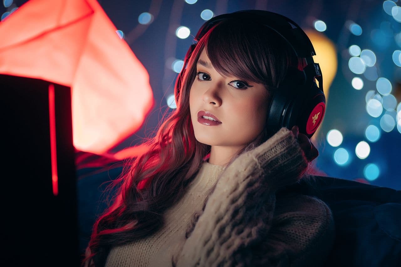 Woman wearing headphones while gaming at a computer