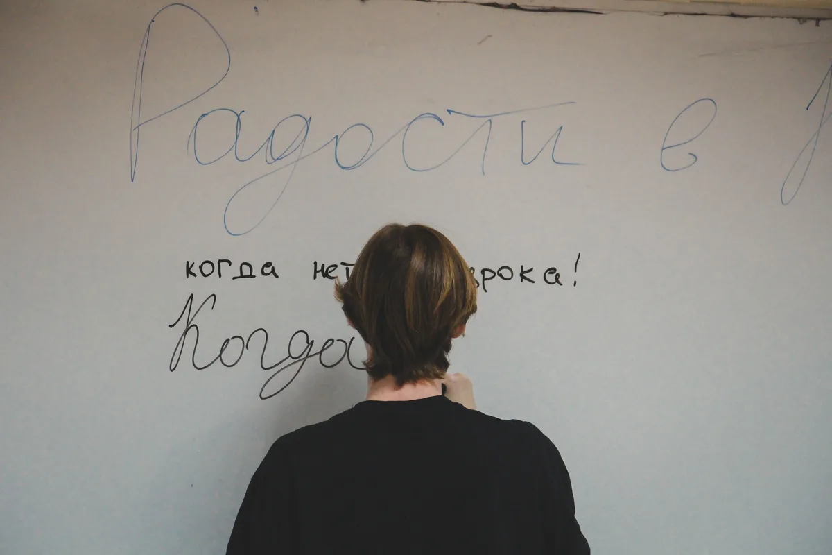 Person watching television, seen from behind, using shows as language immersion practice